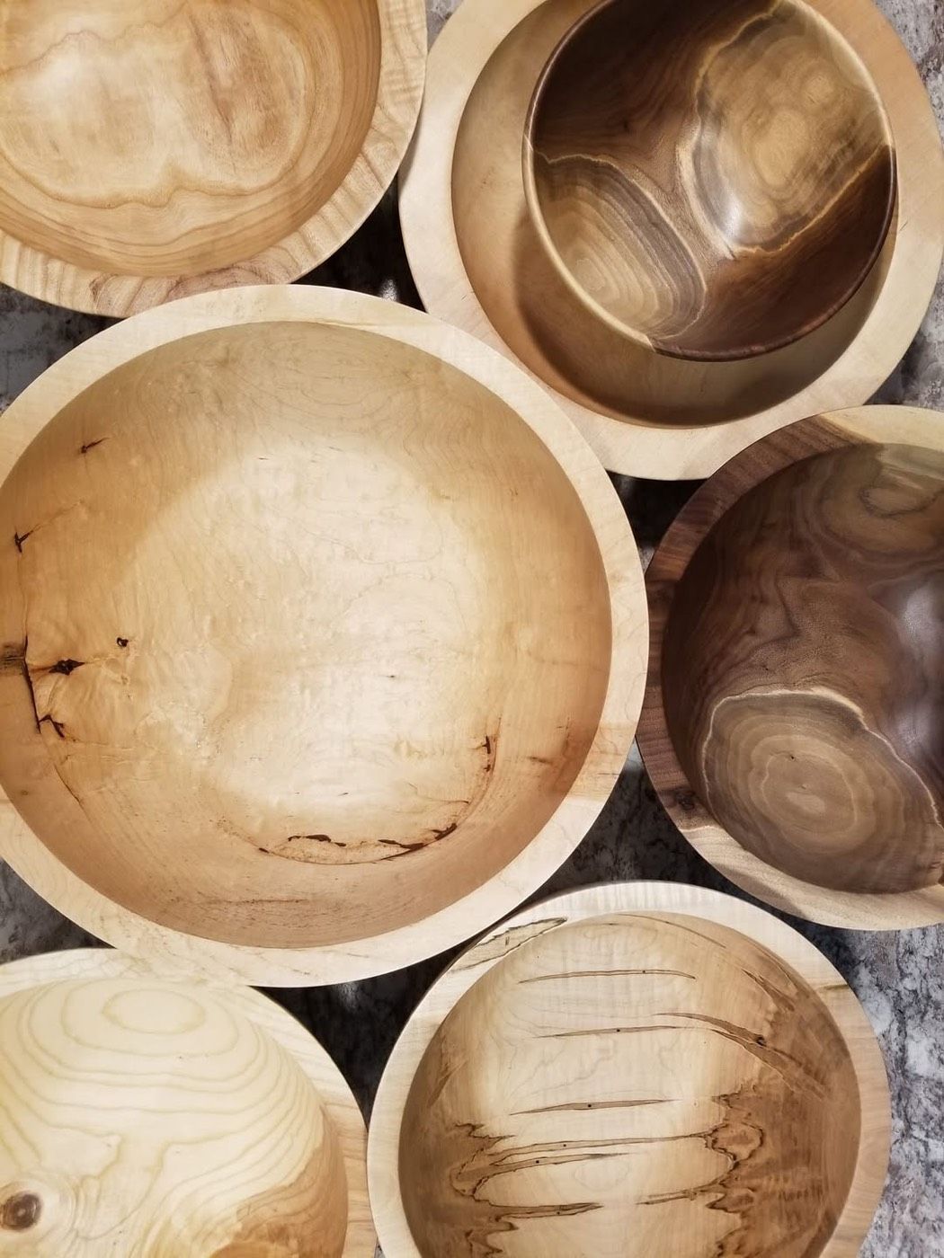 A collection of finished bowls in light and dark woods